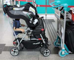 One way to carry the car seat in a sit-and-stand double stroller. 